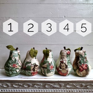 May include: Five fabric pears with different patterns and colours. The pears are numbered 1 through 5.
