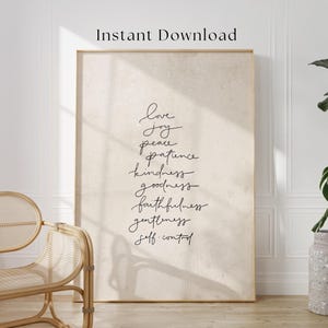 May include: A framed print with a beige background and black script. The text includes words like "love," "joy," and "peace." The words are arranged vertically. The phrase "Instant Download" is at the top.