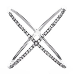 May include: A silver-toned ring with an X-shaped design. The ring features a double band that crosses in the center. One band is encrusted with small, clear gemstones. The ring is set against a white background.