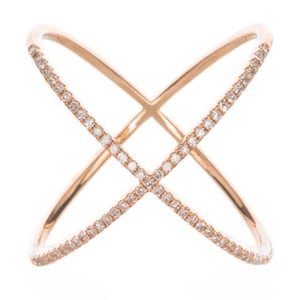 May include: Rose gold criss-cross ring with a double band design. The ring is encrusted with small, sparkling diamonds along the top of each band. The ring is set against a white background.