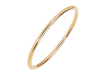 May include: A simple gold ring with a smooth, polished finish.