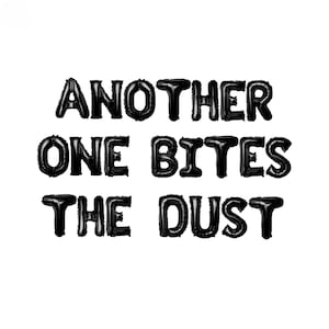 May include: Black balloon letters spelling out the phrase "Another One Bites The Dust".