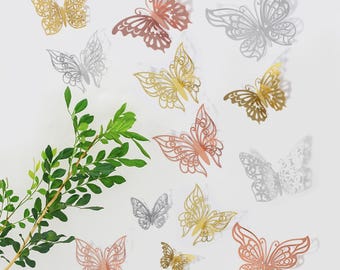 May include: Assortment of decorative 3D butterfly wall decals in gold, silver, and rose gold. The butterflies have intricate cut-out designs and are perfect for adding a touch of elegance to any room.