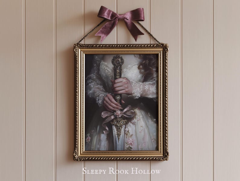 May include: A framed print of a woman in a white dress holding a sword with a gold handle. The frame is gold with a decorative border. The text "SLEEPY ROOK HOLLOW" is printed below the frame.