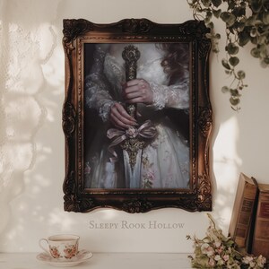 May include: A framed portrait of a person in a white dress holding a sword with a floral design. The frame is ornate and has a dark brown finish. The text "SLEEPY ROOK HOLLOW" is printed below the frame.