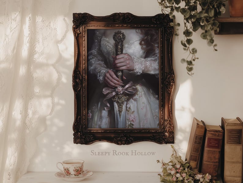 May include: A framed portrait of a person in a white dress holding a sword with a floral design. The frame is ornate and has a dark brown finish. The text "SLEEPY ROOK HOLLOW" is printed below the frame.