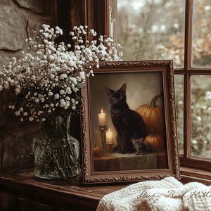 May include: A framed painting of a black cat with a kitten and pumpkins, lit by candles. The painting is on a wooden surface, next to a vase of white flowers. The text "Sleepy Reed Hollow" is visible on a blanket.
