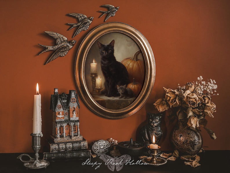 May include: An oval framed painting of a black cat with candles and pumpkins, surrounded by decorative elements. Includes metal swallows, a candle, a haunted house figurine, and dried flowers. The overall theme is Halloween and gothic decor.