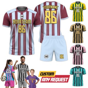 May include: A soccer uniform set with a maroon and light blue striped jersey, white shorts, and the number 86. Additional jerseys in yellow, brown, pink, and teal are displayed. The text "YOURTEAM", "YOURNAME", and "CUSTOM ANY REQUEST" are visible.