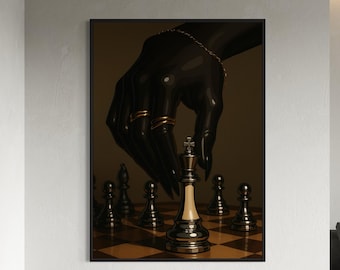 May include: A framed art print featuring a black hand adorned with gold rings and a bracelet, positioned above a chessboard. The king chess piece is in focus, with other pieces visible. The artwork has a dark, dramatic aesthetic.