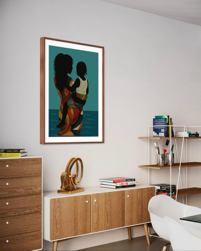 May include: A framed art print featuring a silhouette of a person holding a child. The figures are black against a teal background with a depiction of water. The person's clothing is patterned with orange, yellow, and blue. The frame is brown.
