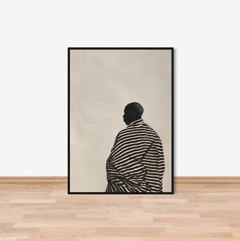 May include: Art print depicting a person in silhouette, wearing a black and white striped garment. The image is framed in black, with a neutral background. The artwork is a minimalist design.
