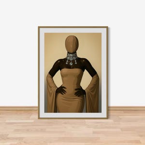 May include: A framed art print depicting a faceless figure in a gold dress with long, flowing sleeves. The figure wears a sparkling jeweled collar and has their hands on their hips. The background is a light tan colour.
