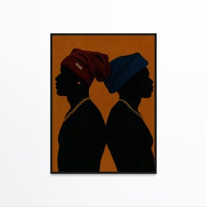 May include: A framed art print featuring two black silhouettes facing opposite directions. Each figure wears a beanie, one burgundy and one blue, and a gold chain. The background is a solid orange color.