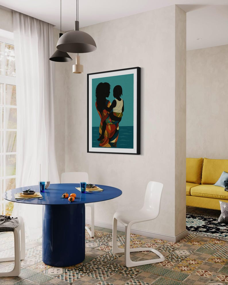 May include: A framed art print depicting a mother and child in silhouette, set against a teal background with a suggestion of water. The mother wears a colorful patterned garment. The scene is in a dining room with a blue table and white chairs.