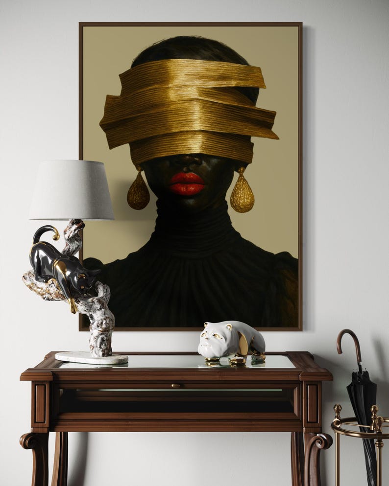 May include: A framed portrait of a person with dark skin, red lips, and gold-colored blindfold and earrings. A black and white panther lamp and a bulldog figurine sit on a dark wood table. An umbrella stand is in the background.