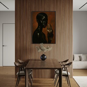 May include: A framed portrait of a person holding a glass of wine, with a dark complexion and red lipstick. The artwork hangs on a wooden slatted wall, above a wooden dining table with four chairs. A vase with decorative branches sits on the table.