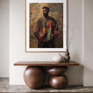 K&ouml;nnte beinhalten: Gerahmter Kunstdruck mit einer Person in einem farbenfrohen Patchwork-Pullover vor floralem Hintergrund. Der Druck h&auml;ngt &uuml;ber einer Holzkonsolentisch mit abgerundeten Beinen und dekorativen Vasen.