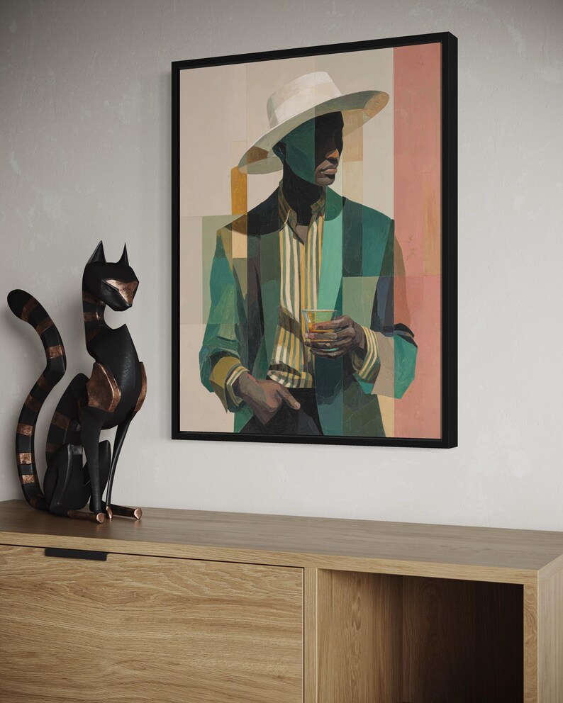 May include: Framed art print featuring a stylized portrait of a person in a green blazer, striped shirt, and white hat. The artwork has a geometric design with a drink in hand. The art is displayed above a wooden cabinet with a black cat sculpture.