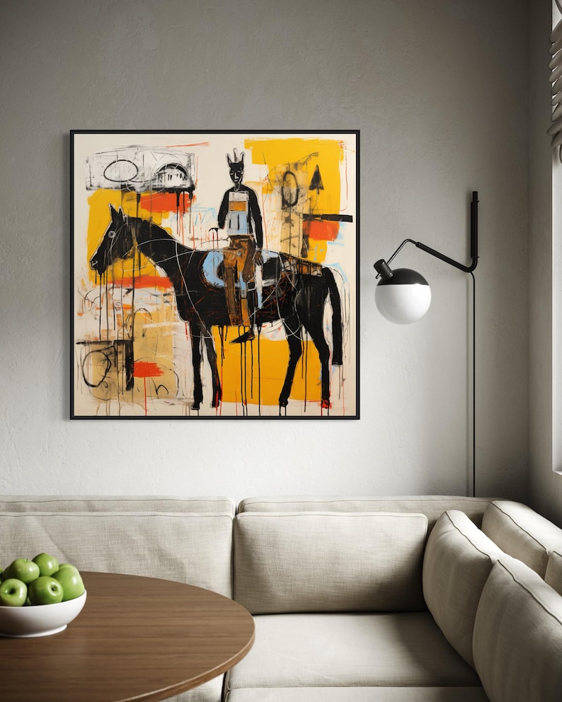 May include: Abstract artwork depicting a black horse and rider against a yellow and white backdrop. The painting, with its bold brushstrokes and minimalist style, is framed in black. It's displayed on a grey wall.
