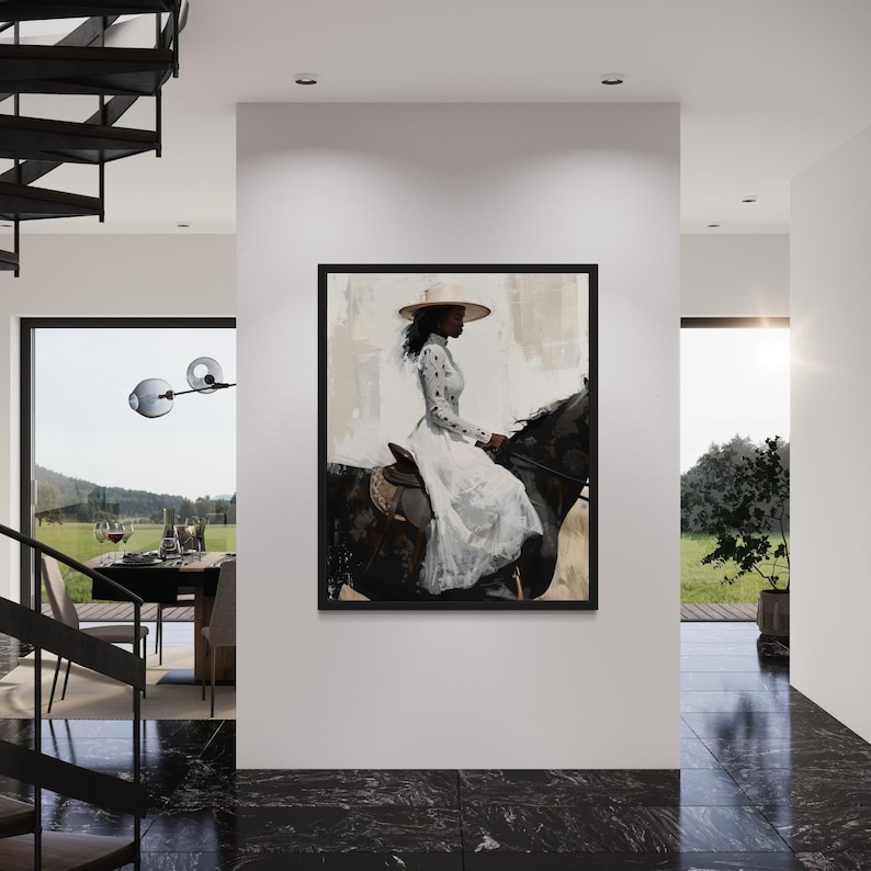 May include: A framed artwork showing a person on a black horse, wearing a white dress and a wide-brimmed hat. The background has neutral tones. The artwork is displayed on a white wall in a modern interior, with a black marble floor.