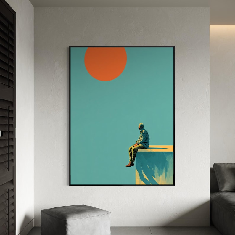 May include: A framed art print featuring a person sitting on a ledge under a large orange sun against a teal sky. The person is wearing a green shirt and pants. The artwork has a minimalist, modern aesthetic.