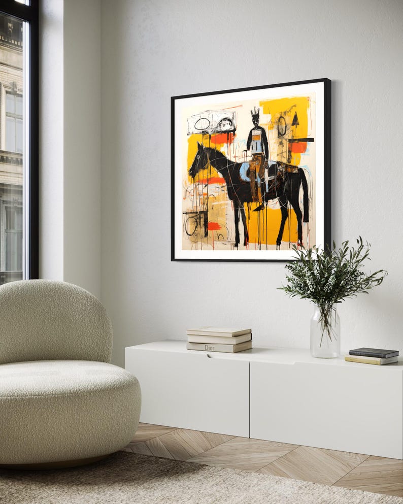 May include: Abstract art print depicting a black horse and rider set against a yellow and white backdrop. The artwork is framed in black and hangs on a white wall. The style is modern and expressive, suitable for home decor.
