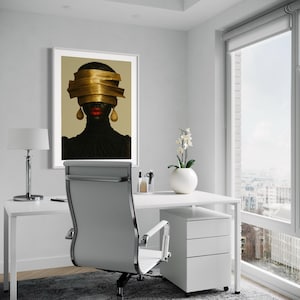 May include: An office setting with a white desk, chair, and a framed artwork. The artwork features a portrait of a person with gold headwear and red lips. A white lamp and a vase with flowers are also visible.