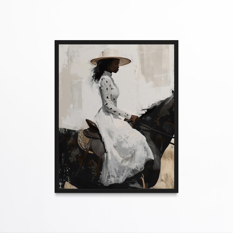 May include: A framed art print depicts a person riding a black horse. The person is wearing a long white dress and a wide-brimmed hat. The artwork has a painterly style with a neutral color palette, featuring shades of white, black, and beige.