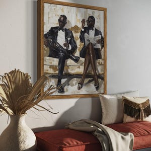 May include: A framed artwork depicts two figures in formal attire seated on a sofa. The figures are wearing black suits, bow ties, and sunglasses. One holds a glass, the other a newspaper. The artwork is displayed above a red bench with decorative pillows.
