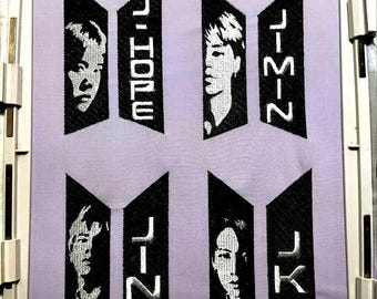 May include: Embroidered patches featuring the names and faces of the members of the K-pop group BTS. The patches are black with white lettering and faces. The names are J-Hope, Jimin, Jin, and JK.