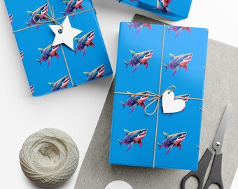 May include: Two rectangular gift boxes wrapped in bright blue paper featuring a repeating pattern of colorful sharks. Each box is tied with thin brown twine and adorned with a white paper gift tag, one star-shaped and one heart-shaped.