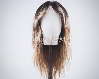 May include: A long, layered wig featuring a dark brown root color that transitions into a lighter blonde shade. The wig is displayed on a white mannequin head and includes the text Wigs-forMe centered across the front of the hair strands.
