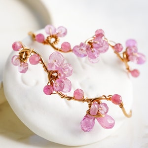 The hoop is curved to resemble a real vine and look like cherry blossom dangling from your ear.