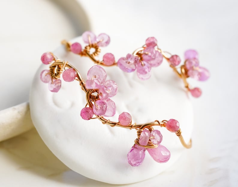 The hoop is curved to resemble a real vine and look like cherry blossom dangling from your ear.