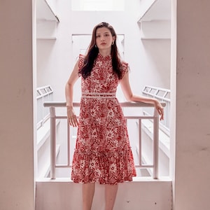 Lady wearing a red and white batik cheongsam dress