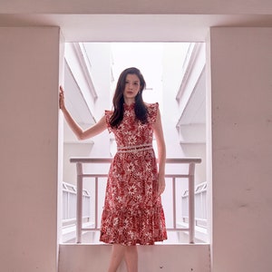 Lady wearing a red and white batik cheongsam dress