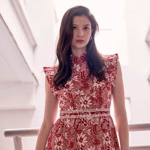 Lady wearing a red and white batik cheongsam dress