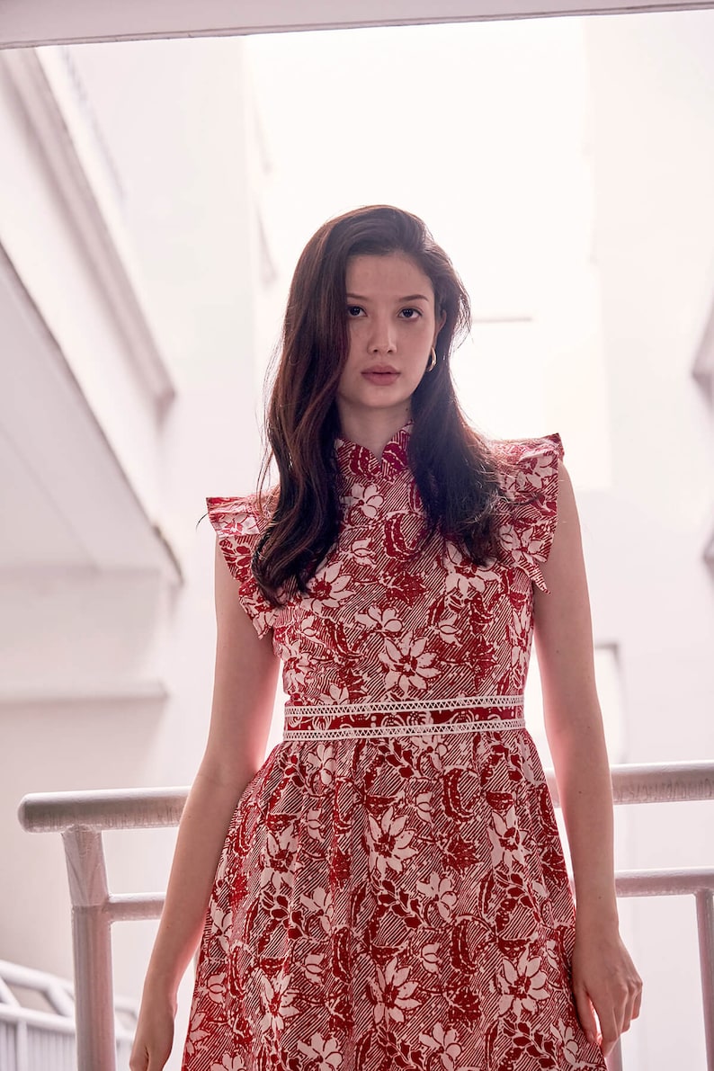 Lady wearing a red and white batik cheongsam dress