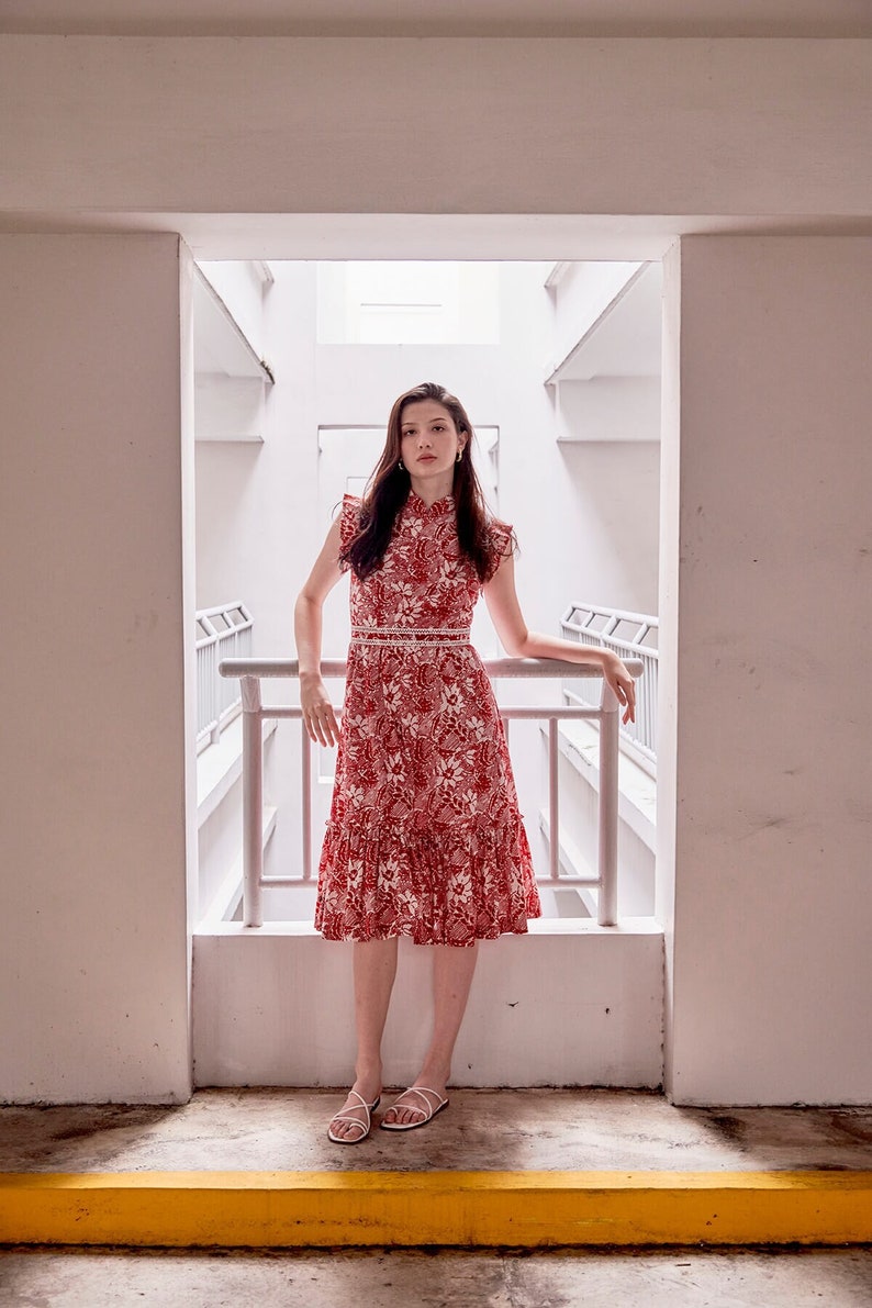 Lady wearing a red and white batik cheongsam dress