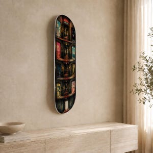 May include: A skateboard deck featuring a vertical, multi-level illustration of a building interior with various colourful doorways and a sign at the top that reads HOTEL NOWHERE. The artwork displays a dark, atmospheric corridor with multiple rooms.