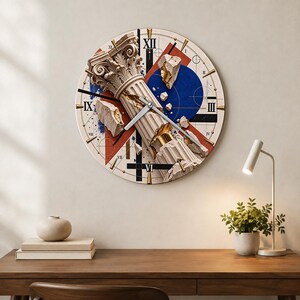 May include: A round wall clock featuring a central image of a broken classical stone column with gold accents. The background includes geometric shapes in red, blue, and black, with Roman numerals marking the hours and thin silver clock hands.