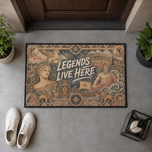 May include: A rectangular doormat featuring a detailed illustration of Greek mythology figures, including a statue bust, a bearded deity with a trident, a winged horse, and a ship. The text "LEGENDS LIVE HERE" is printed in the centre in white.