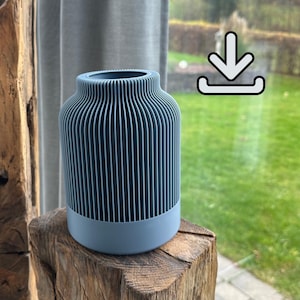 May include: A blue vase with a ribbed design. The vase has a cylindrical shape with a rounded base and a wider top. The vase is sitting on a wooden surface.