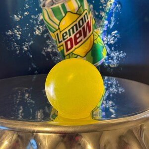 May include: A rustic wooden sign with the text "Welcome" in a handwritten style. The sign is painted white with a distressed finish, and features a decorative floral element in the corner. The background is a blurred image of a wooden surface.