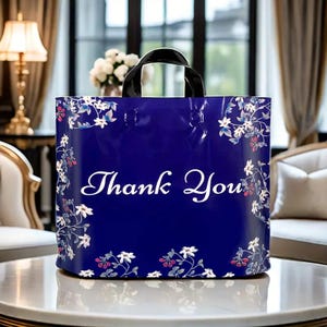 May include: A blue plastic shopping bag with a white floral print and the words "Thank You" in white.