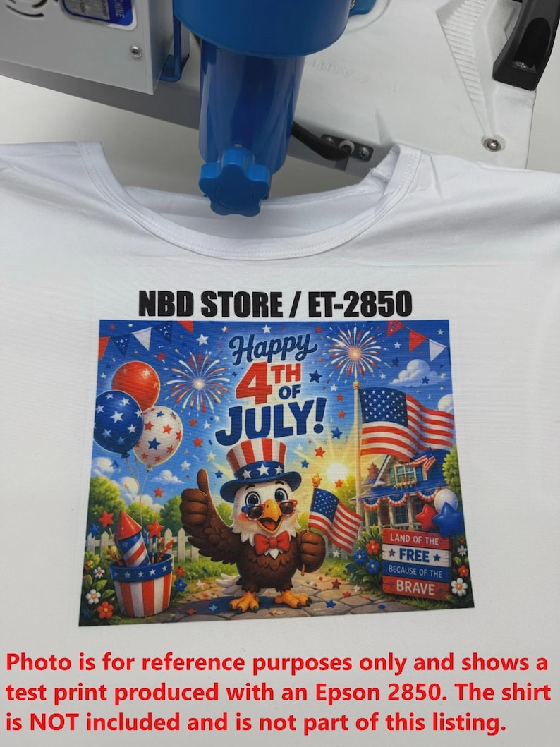 May include: White t-shirt with a colourful graphic print for the 4th of July. The design features an eagle wearing a patriotic hat, fireworks, American flags, and the text "Happy 4th of July!" The text "NBD STORE / ET-2850" is also visible.