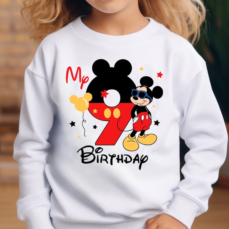 May include: White sweatshirt featuring a Mickey Mouse design for a ninth birthday. The design includes a large number 9 in red, Mickey Mouse wearing sunglasses, and the words "My Birthday".