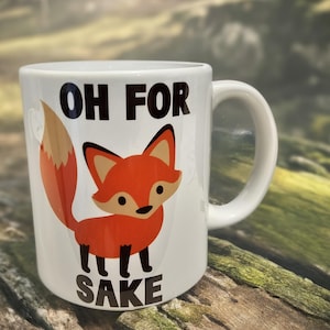 May include: White ceramic mug featuring a red fox illustration and the text "OH FOR SAKE" in black.