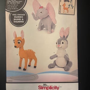 May include: A Simplicity sewing pattern envelope 8542 featuring Disney characters Dumbo, Bambi, and Thumper. The front displays illustrations of the finished plush toys with listed heights of 11.25 inches, 18 inches, and 16 inches respectively.